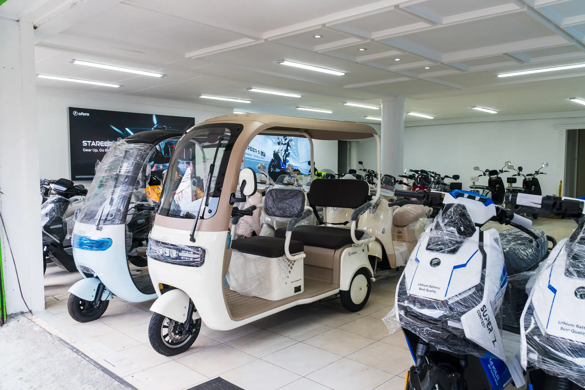 OFERO showroom reference photograph with electric vehicles on display
